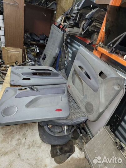 Обшивка карта двери на чери тиго 2010г