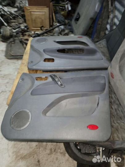 Обшивка карта двери на чери тиго 2010г