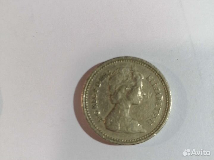 Монета один паунд