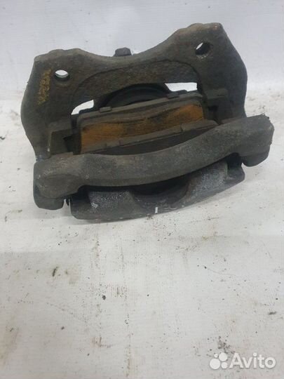 Суппорт тормозной передний левый Nissan Almera N16