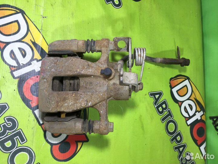 Суппорт тормозной задний левый Kia Rio 3