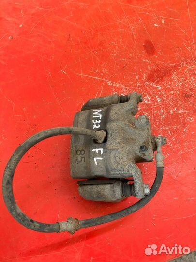 Суппорт тормозной передний левый Nissan Teana J32