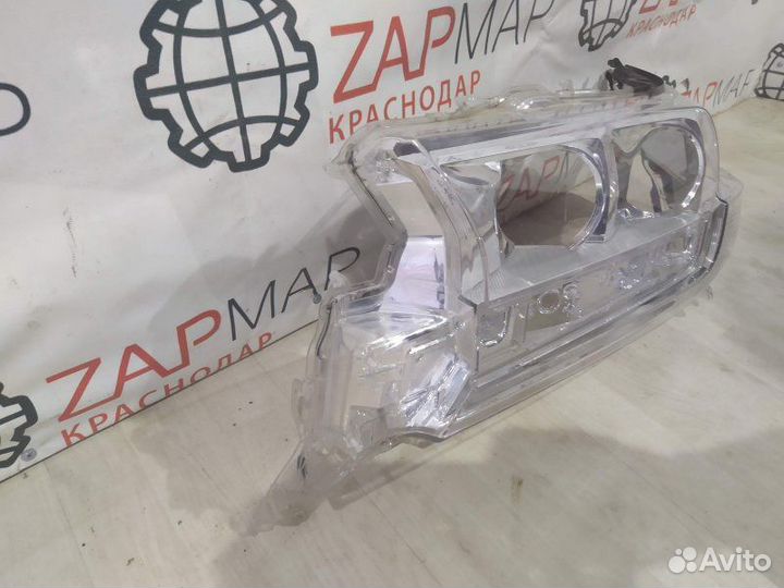 Стекло фары левое Toyota Land Cruiser J200