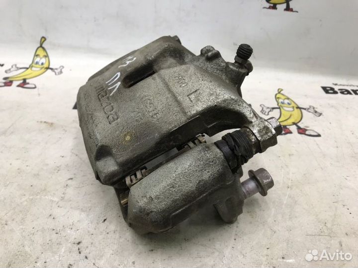 Суппорт тормозной передний левый Mazda 3 BM