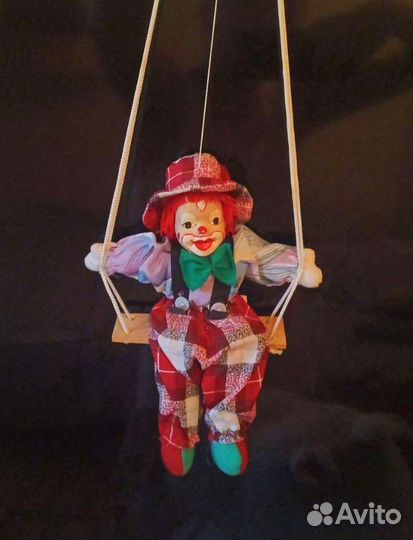 Фарфоровый клоун на качели