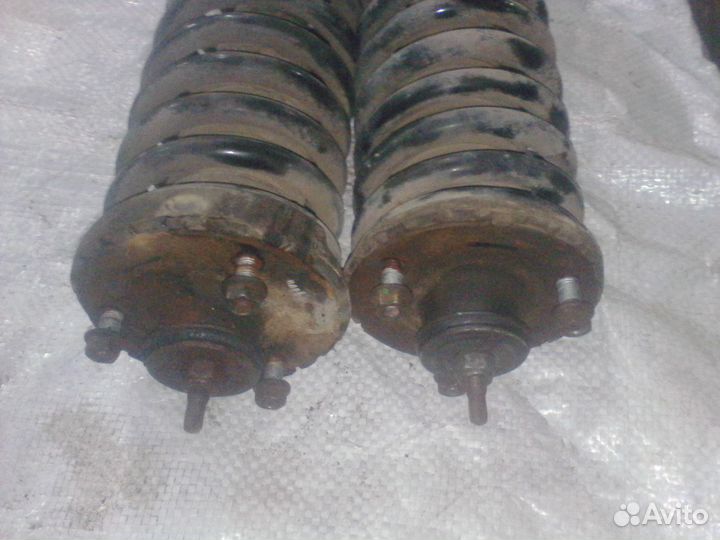 Стойки пер. в сборе на Сан Енг Кайрон 2.3 АКПП 13г