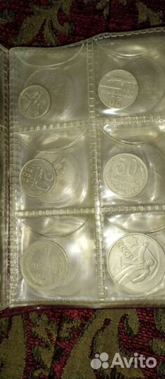 Два альбома с монетами разных времён и эпох