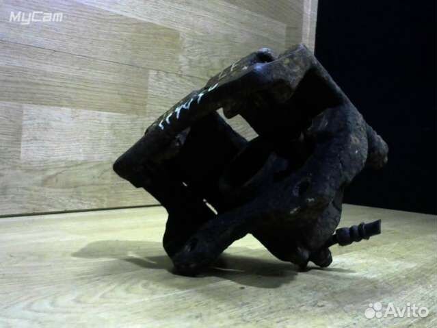 Суппорт тормозной передний левый Nissan Almera Tin