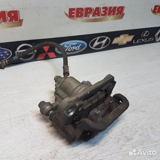 Суппорт тормозной задний левый Nissan Teana J32