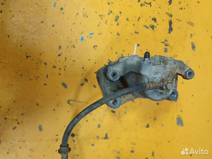 Суппорт тормозной передний левый Nissan Teana