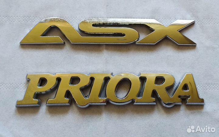 Эмблемы Priora и ASX