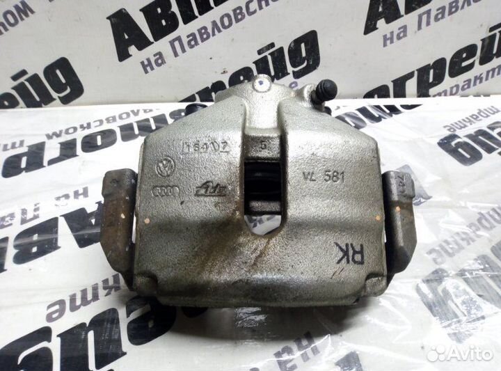 Суппорт тормозной передний левый Volkswagen Passat