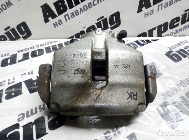 Суппорт тормозной передний левый Volkswagen Passat