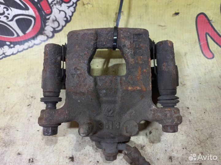 Суппорт тормозной задний левый Nissan Teana J31