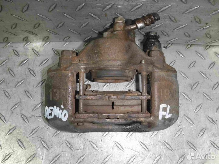 Суппорт тормозной передний левый Mazda Demio