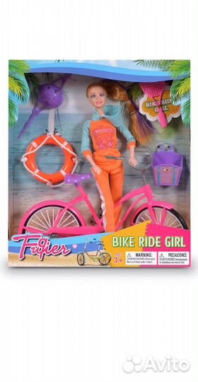 Игрушка кукла на велосипеде