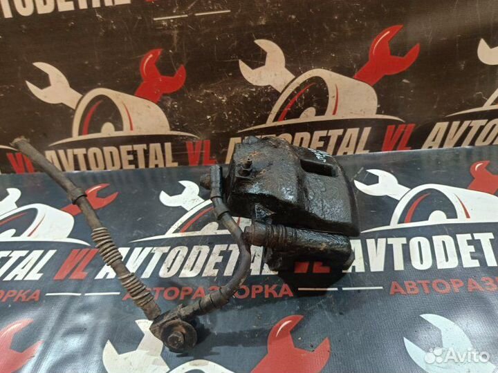 Суппорт тормозной передний левый Nissan Primera