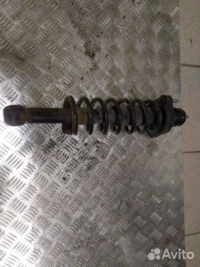 Стойка амортизатора задняя Mitsubishi Lancer седан