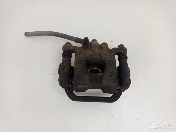 Суппорт тормозной задний левый Nissan Tiida HR16DE