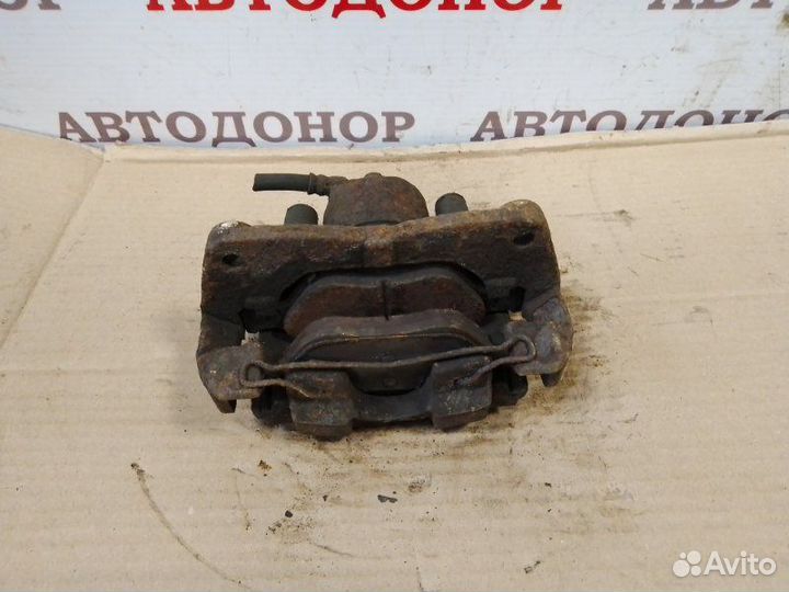 Суппорт тормозной передний левый Toyota Yaris 2