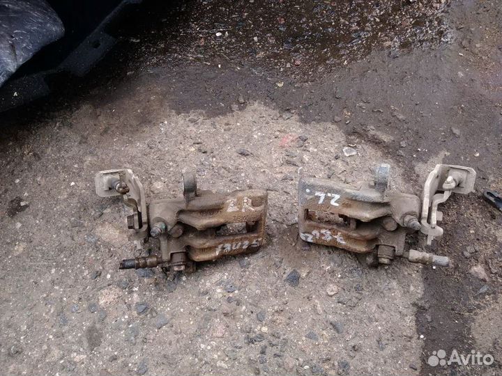 Суппорт тормозной задний левый Nissan Almera N16