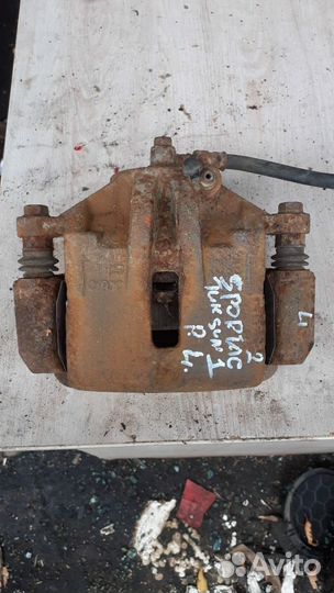 Суппорт тормозной передний левый Kia Sportage II